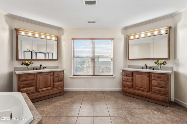 full bath with two vanities, a sink, and visible vents