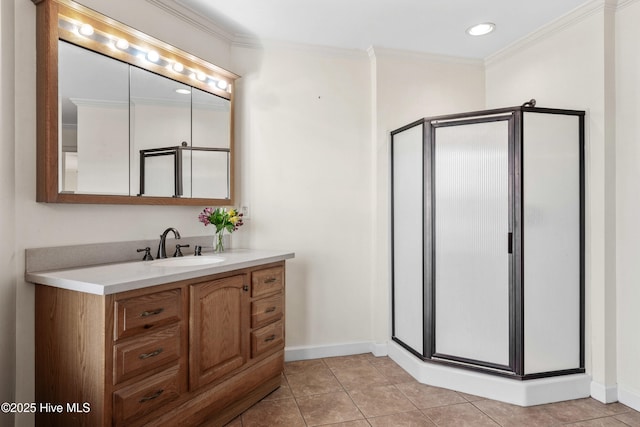 bathroom featuring a shower stall, vanity, ornamental molding, and tile patterned floors