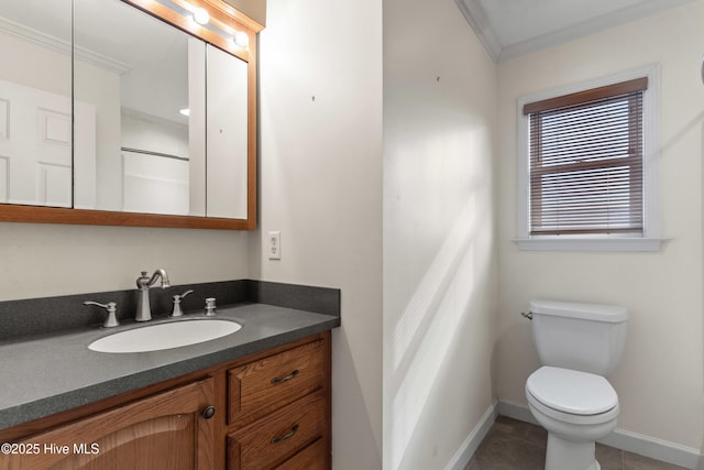 bathroom with toilet, tile patterned floors, baseboards, and vanity