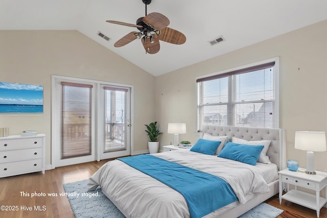 bedroom with access to outside, visible vents, lofted ceiling, and light wood finished floors