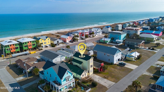 bird's eye view featuring a beach view, a water view, and a residential view