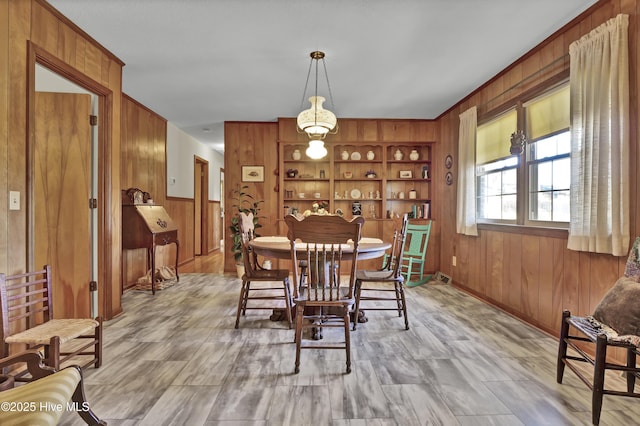 dining space featuring wooden walls and built in features