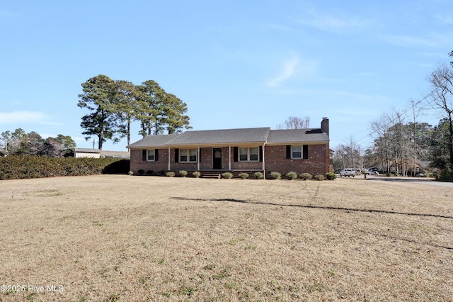 ranch-style home with a front lawn and covered porch