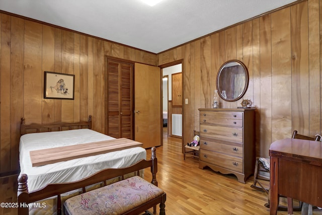 bedroom featuring light wood-type flooring and a closet