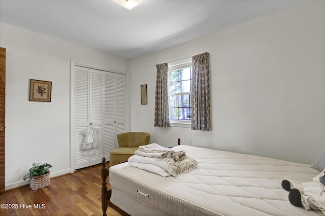 bedroom with hardwood / wood-style floors and a closet