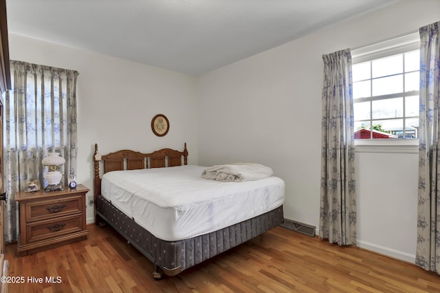 bedroom with dark wood-type flooring