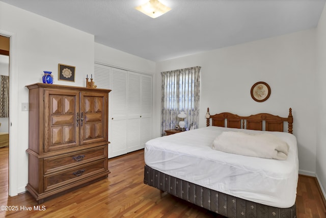 bedroom featuring hardwood / wood-style floors and a closet