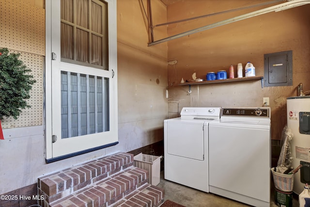 washroom with electric panel, washer and clothes dryer, and water heater