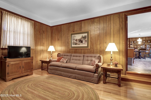 living room with wooden walls and light hardwood / wood-style floors