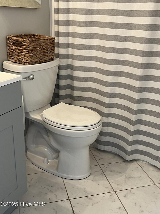 1801 Canal Dr Unit D14, Carolina Beach, NC 28428 - bathroom featuring marble look tiles, toilet, and vanity