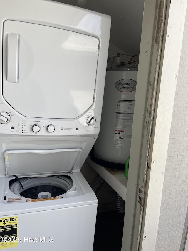 1801 Canal Dr Unit D14, Carolina Beach, NC 28428 - washroom with stacked washer / dryer and electric water heater