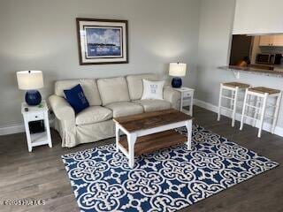 living room with wood finished floors and baseboards