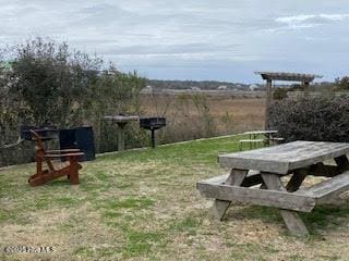 view of property's community with a lawn