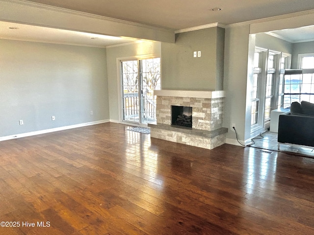 unfurnished living room with crown molding, a stone fireplace, and dark hardwood / wood-style flooring