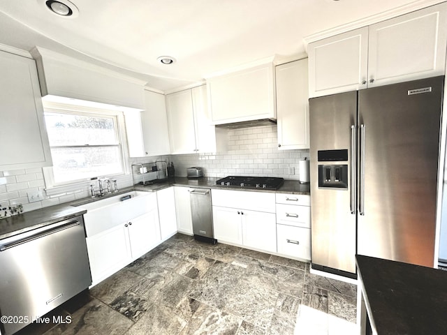 kitchen featuring dishwashing machine, white cabinetry, backsplash, black gas cooktop, and high quality fridge