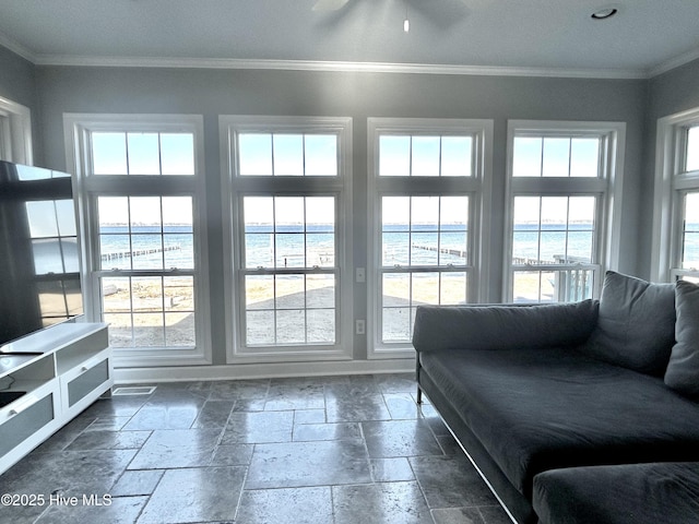 living room with a water view, plenty of natural light, and crown molding