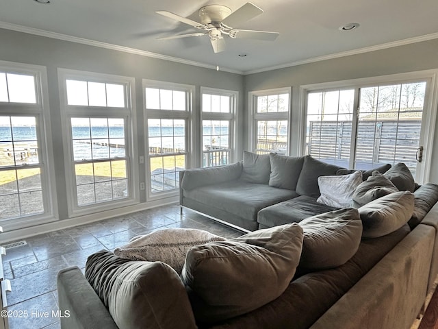 sunroom / solarium featuring a water view, ceiling fan, and a beach view