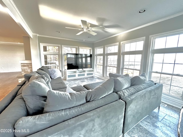 living room with crown molding, ceiling fan, and plenty of natural light