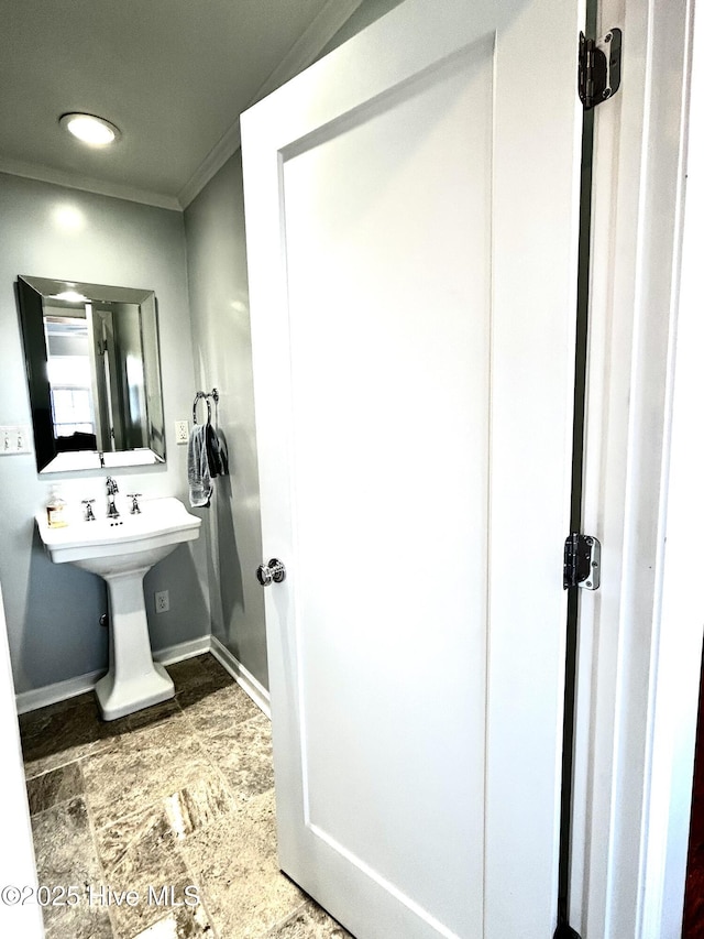 bathroom with sink and crown molding