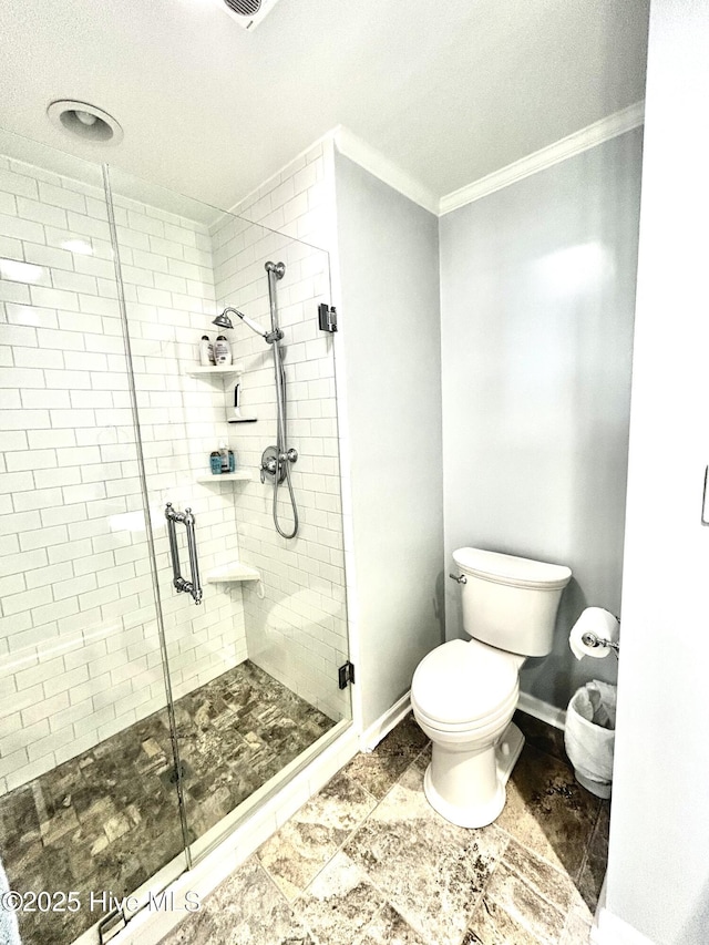 bathroom with crown molding, toilet, and walk in shower