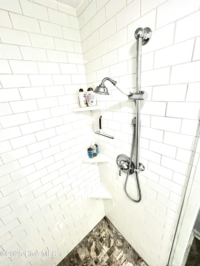 bathroom with tiled shower