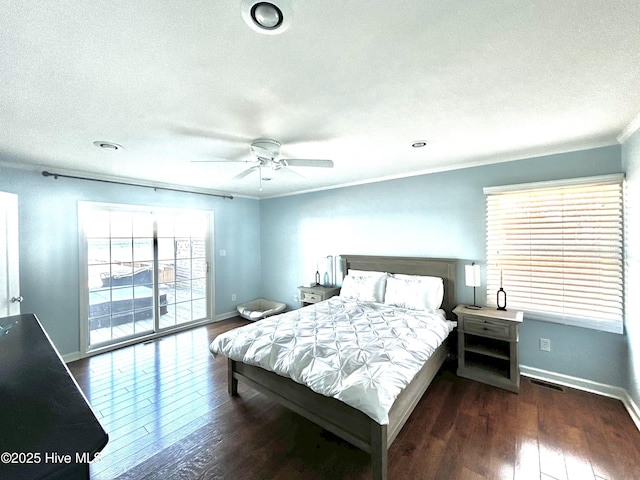 bedroom featuring crown molding, access to outside, dark hardwood / wood-style floors, and a textured ceiling