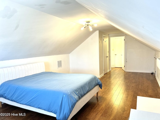 bedroom featuring lofted ceiling and dark hardwood / wood-style flooring