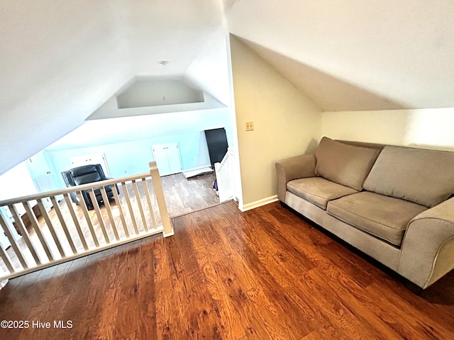 living room with a baseboard radiator, wood-type flooring, radiator, and vaulted ceiling