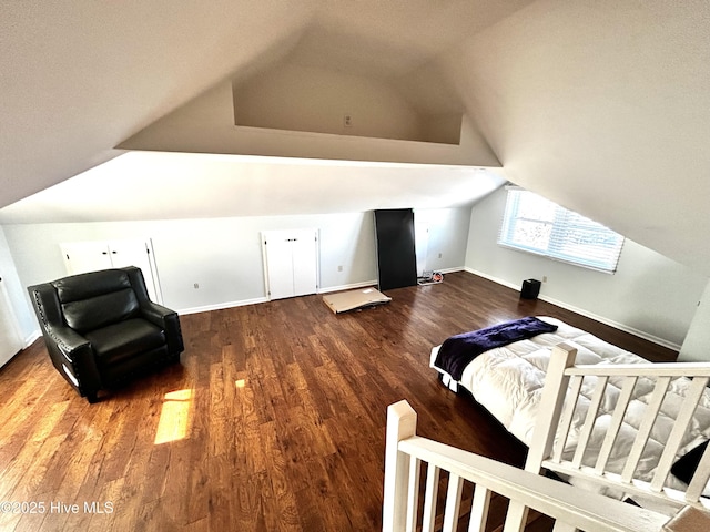 bedroom with vaulted ceiling and wood-type flooring