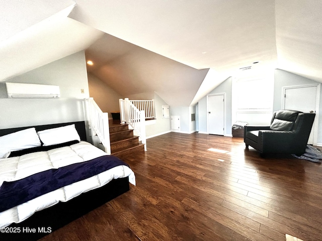 bedroom with dark hardwood / wood-style flooring, a wall mounted air conditioner, and vaulted ceiling