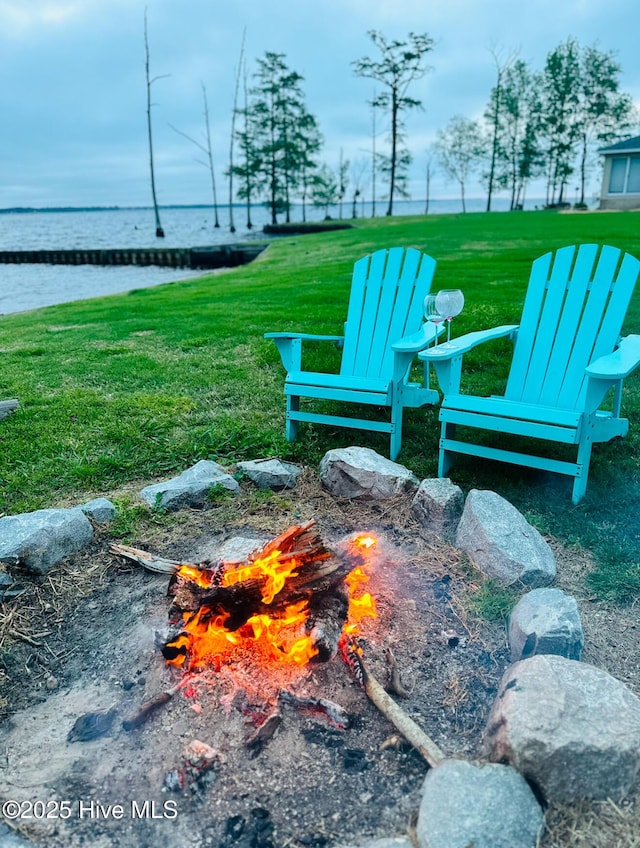 view of property's community with a water view and a lawn