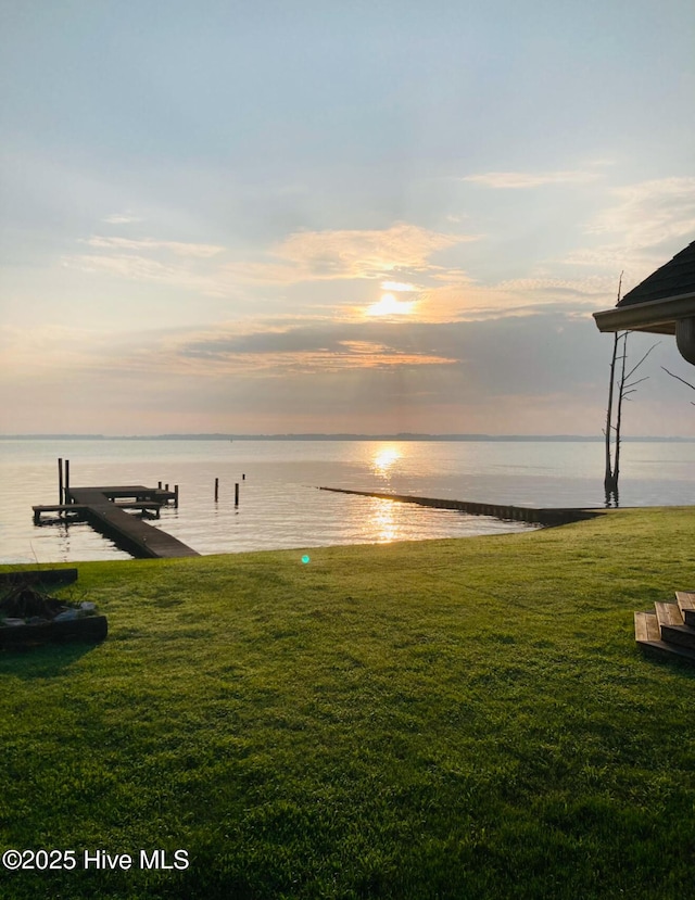 exterior space featuring a water view and a lawn