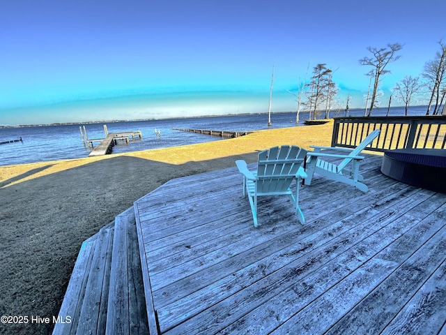 dock area with a water view and a yard