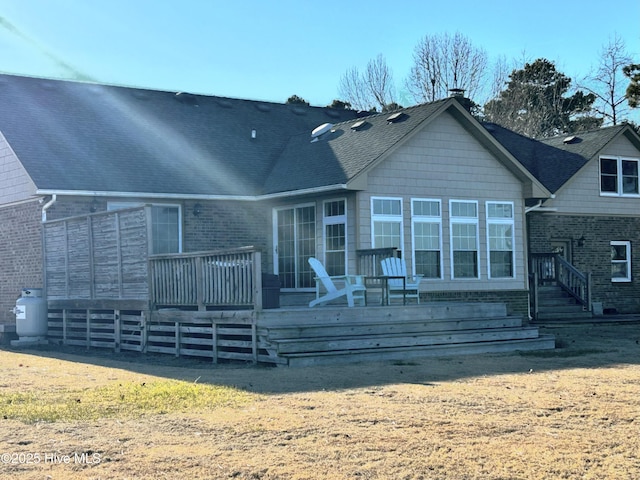 back of house featuring a wooden deck and a yard