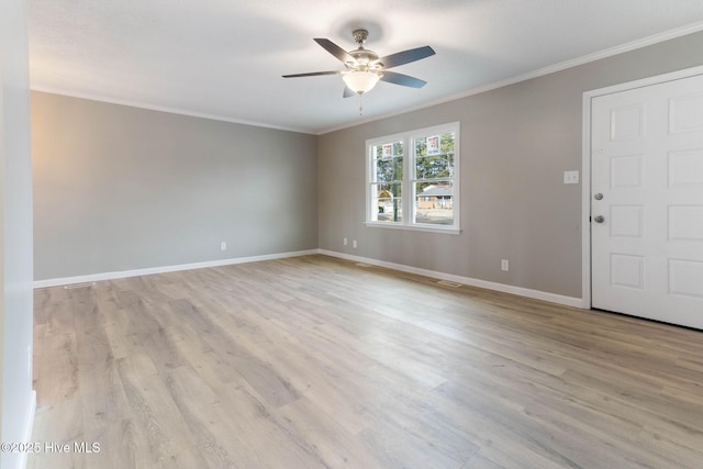 empty room featuring crown molding, ceiling fan, and light wood-type flooring