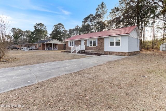 ranch-style house featuring a carport, a shed, and a front lawn