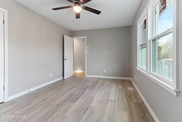 unfurnished room with ceiling fan and light wood-type flooring