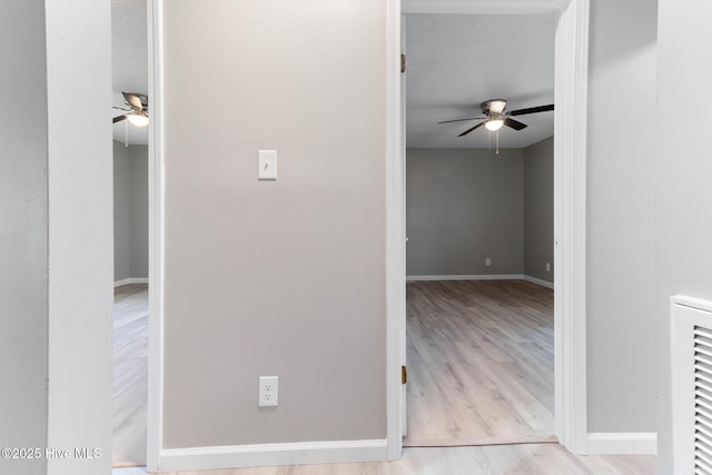 corridor with light hardwood / wood-style flooring