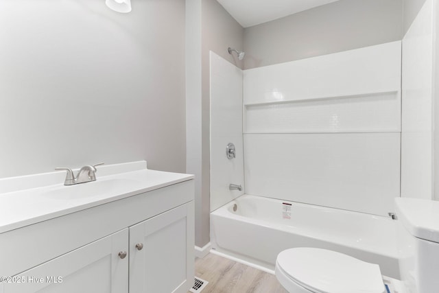 full bathroom featuring shower / tub combination, vanity, toilet, and hardwood / wood-style floors