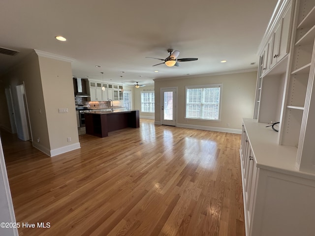 kitchen with decorative backsplash, crown molding, double oven range, and open floor plan