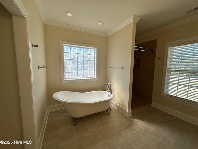 bathroom featuring a freestanding bath, visible vents, a wealth of natural light, and ornamental molding