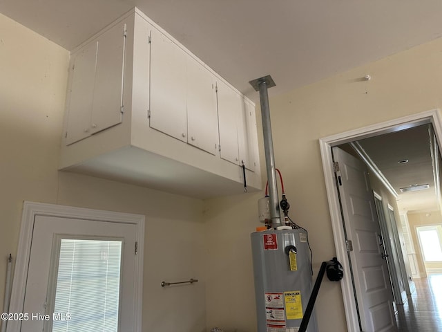 utility room with gas water heater and visible vents