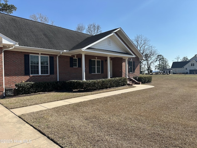 view of front of property featuring brick siding and covered porch