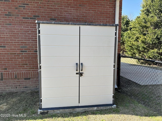 view of outbuilding with fence