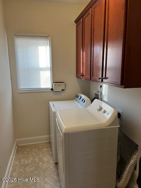 laundry room with cabinets and separate washer and dryer