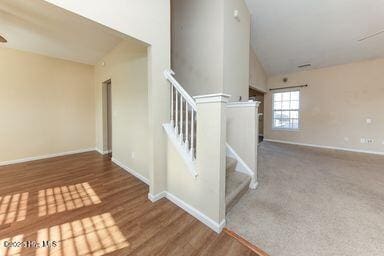 carpeted spare room featuring ceiling fan