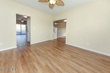 spare room with wood-type flooring and ceiling fan