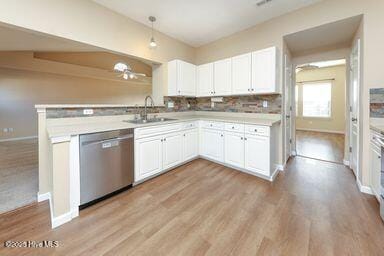 kitchen featuring sink, white cabinetry, hanging light fixtures, light hardwood / wood-style flooring, and dishwasher