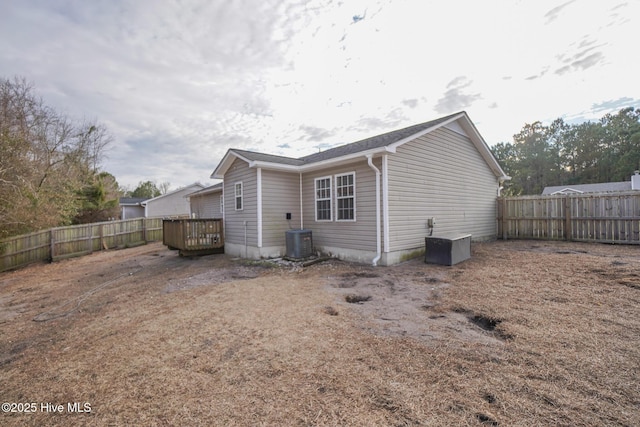 rear view of property with cooling unit and a deck