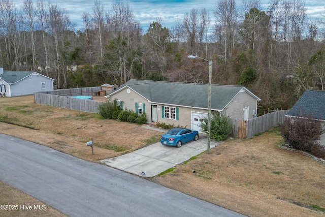 ranch-style house with a garage and a front lawn